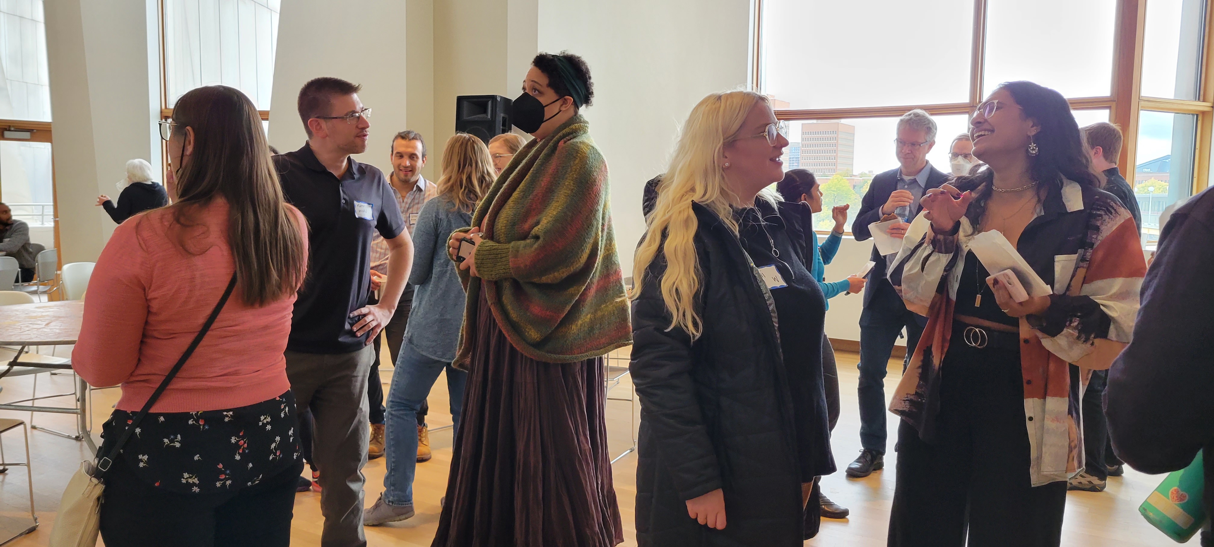 Group of attendees chatting in the Weisman gallery during the coffee break